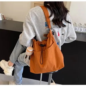 Large capacity casual canvas bucket bag for women, stylish daily shoulder and crossbody bag.