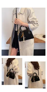 Chic black retro soft leather bowling bag, versatile top handle shoulder and crossbody bag for women.