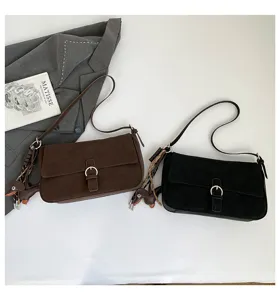 Detail view of stylish retro shoulder bags featuring cute dog charms and chic metal buckles.