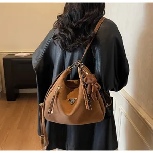 Brown faux leather convertible backpack detail, chic metal triangle logo and cute bear pendant.