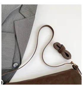Vintage brown shoulder crossbody bag for women, retro underarm bag with detailed strap design.
