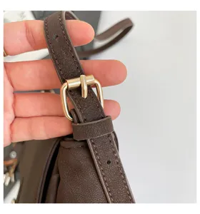 Brown vintage women shoulder bag strap detail, premium PU leather with gold buckle.