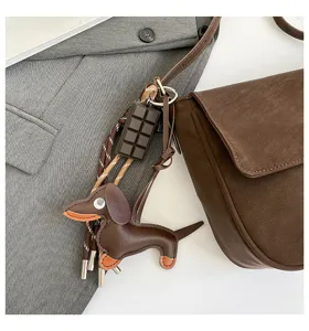 Retro brown shoulder bag detail featuring cute dachshund and chocolate charms for women winter.