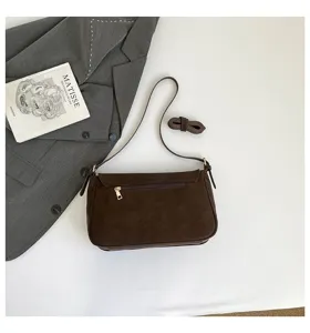 Detailed view of brown vintage underarm shoulder bag with zipper and adjustable strap.