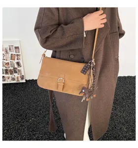 Vintage brown shoulder bag for women, elegant winter crossbody handbag with cute charms and strap.