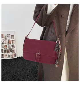 Detailed view of the retro burgundy underarm shoulder bag with chic buckle and winter fashion.