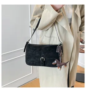 Retro black shoulder underarm bag for women, stylish vintage flap bag with cute charms.