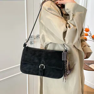 Retro black suede shoulder bag for women, stylish underarm commuter handbag with buckle.
