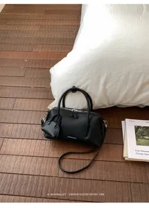 Black litchi pattern Boston handbag for women, chic retro shoulder crossbody bag style.