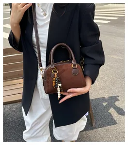 Vintage brown suede bowling shoulder bag, stylish casual crossbody handbag for modern women daily.