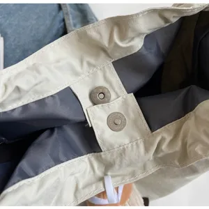 Detailed view of casual bucket bag interior, durable fabric lining, secure metal snap closure.