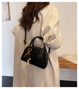 Black vintage bowling bag for women, soft leather crossbody shoulder bag with chic wooden bead.