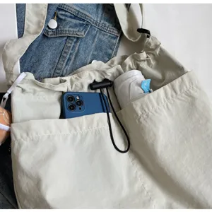 Detailed view of large capacity casual canvas shoulder bag with multi pockets for women daily commute.