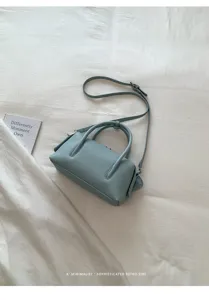 Light blue litchi pattern boston pillow bag, stylish women's shoulder crossbody handbag.