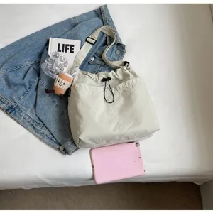 Large capacity casual canvas bucket bag for women, stylish commuting shoulder crossbody bag.