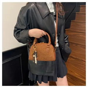 Vintage brown suede bowling handbag detail, chic crossbody shoulder bag with beaded charm.