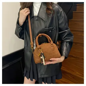 Retro soft leather bowling bag with shoulder strap and chic bead charm for daily fashion style.