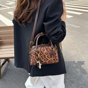 Chic leopard print bowling bag for women, vintage soft leather crossbody and shoulder handbag.