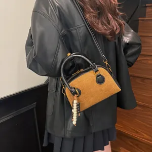 Retro soft leather bowling bag for women, stylish contrast color crossbody shoulder bag with charm.