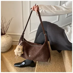 Brown crinkled baguette shoulder bag for women, trendy vintage hobo handbag with cute bear charm.