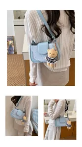 Light blue star pattern shoulder bag with cute bear pendant, stylish baguette bag for women.