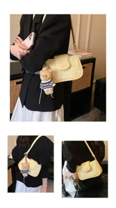 Stylish yellow shoulder bag for women, trendy star print design with cute bear pendant.