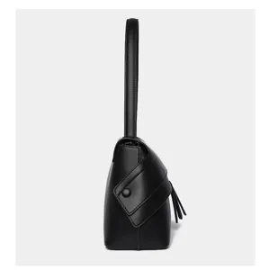 Black minimalist leather underarm shoulder bag side detail showcasing flap and handle design.