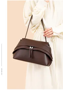 Brown leather underarm shoulder bag for women, stylish vintage design with tassel zipper.