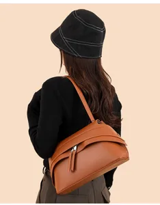 Brown vintage underarm bag detail showcasing PU leather texture and unique structured design.
