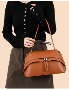 Women's retro underarm shoulder bag, stylish brown leather handbag with double zipper design.
