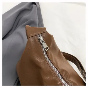 Brown faux leather soft slouchy dumpling bag with silver metal zipper detail view