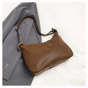 Detailed view of the brown soft leather dumpling shoulder bag, showing fine texture and hardware.