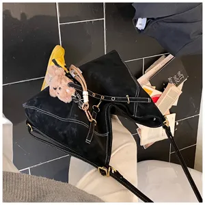 Black matte retro shoulder bag with white stitching, versatile tote bag with cute bear pendant
