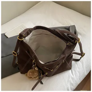 Dark brown multi-functional canvas shoulder tote bag, retro style with metal hardware details.