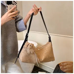 Stylish crinkled baguette shoulder bag for women, chic underarm purse with cute plush pendant.