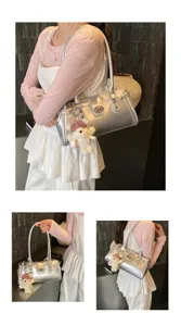 Silver metallic shoulder bag detail, Y2K style underarm bag with cute bear pendant accessory.