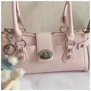 Pink PU leather shoulder bag detail with metal rivets and turn-lock closure for women commuting.