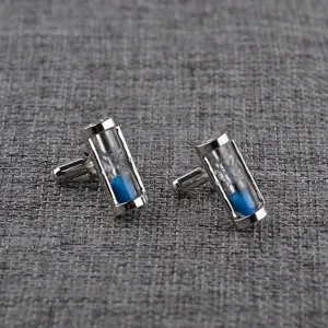 Detailed view of silver-tone hourglass cufflinks with vibrant blue sand for men shirts.