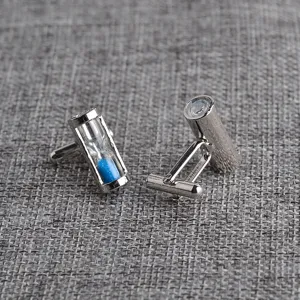 Detailed close-up view of silver-tone hourglass cufflinks with blue sand for men shirts.