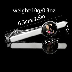 Men's fashion tie clip with letter E glass cabochon and floral design, silver metal finish.