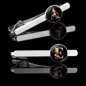 Men's silver letter tie clip with floral glass cabochon design, stylish fashion accessory.