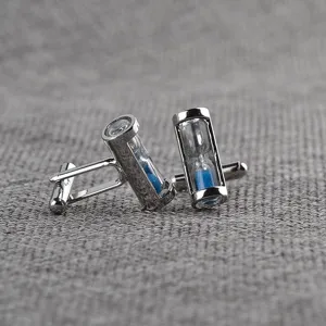 Detailed close-up shot of elegant silver cufflinks featuring a blue hourglass design for men shirt.