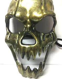Close-up of golden vintage skull mask with big teeth for Halloween horror party props.