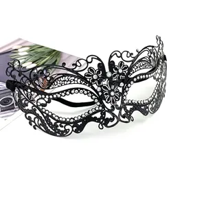 Close-up detail of black metal masquerade mask with sparkling rhinestones and lace.