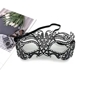 Close-up detail of the black metal rhinestone masquerade mask, showing delicate work.