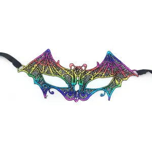 Detail shot of a colorful lace bat mask with rainbow gradient and black ribbons for party.