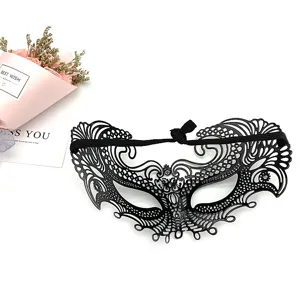 Detailed view of black lace masquerade mask with intricate cutouts and elastic strap.