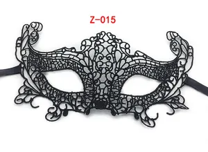 Close-up detail of black lace masquerade mask with intricate hollow patterns and side ties.