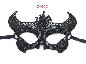 Detail view of black lace masquerade party mask with unique devil horns design and ribbons.