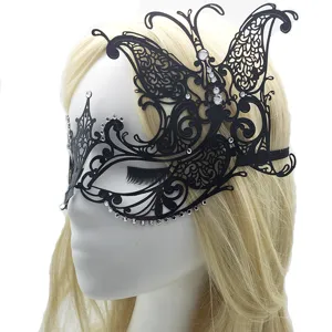 Detail view of a black metal butterfly masquerade mask with rhinestones on a display head.